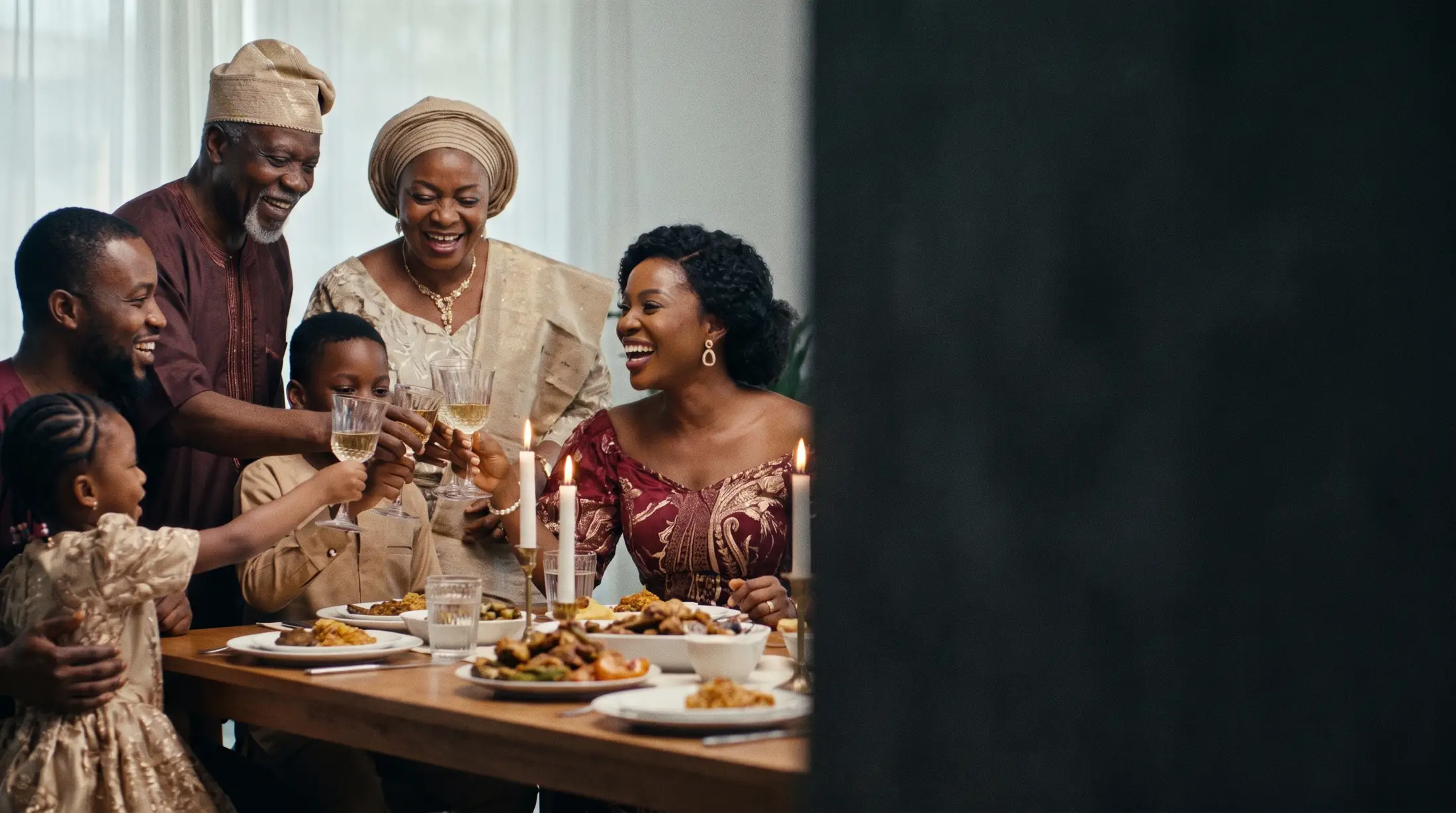 Nigerian family raising a toast at a candlelit celebration